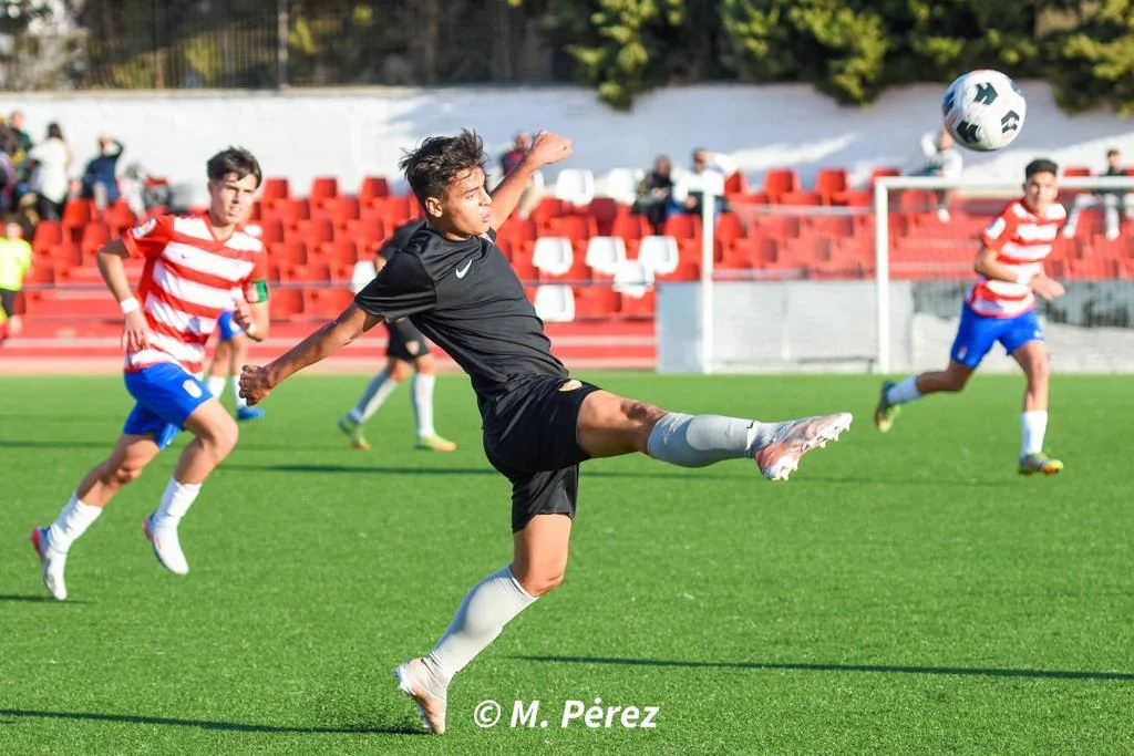 Diego golpea el balón en el Granada CF-Sevilla FC de liga división de honor cadete. 